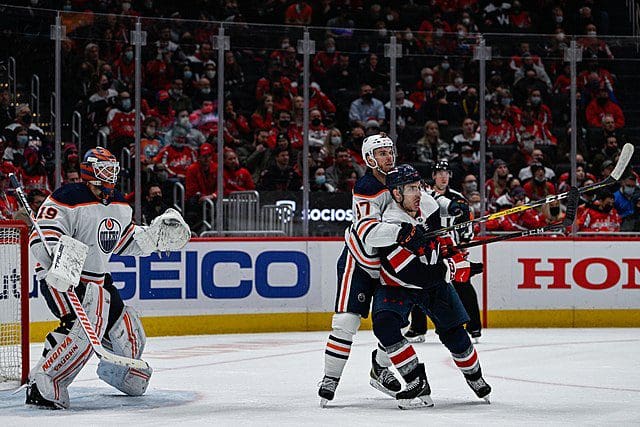 Washington Capitals Garnet Hathaway fights Connor McDavid for positioning in front of the Edmonton Oilers' net at Capital One Arena in Washington D.C., Feb. 2, 2022. (Photo by Brian Murphy, All-Pro Reels)